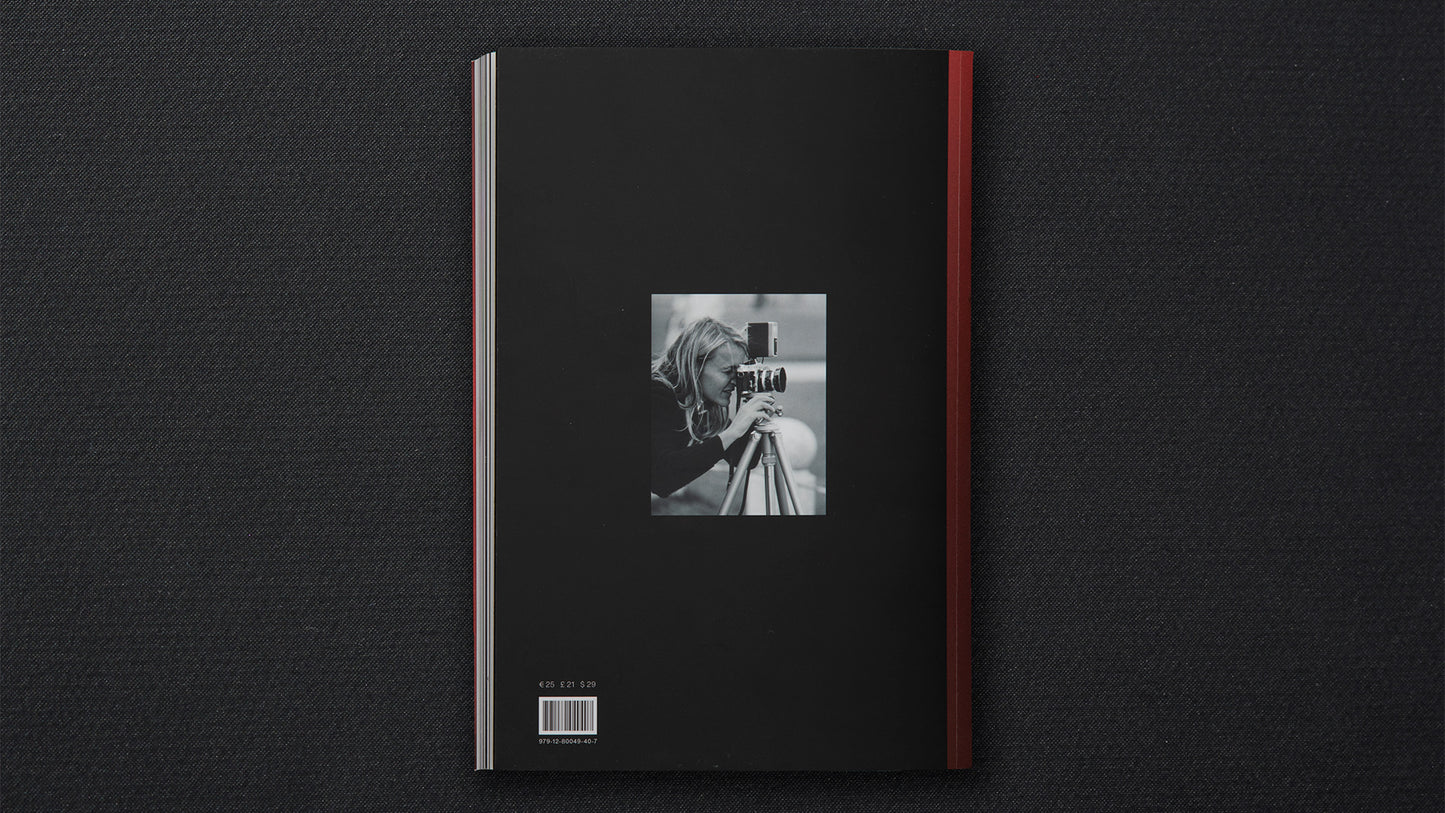 Black book cover with a red ribbon on a dark textured background