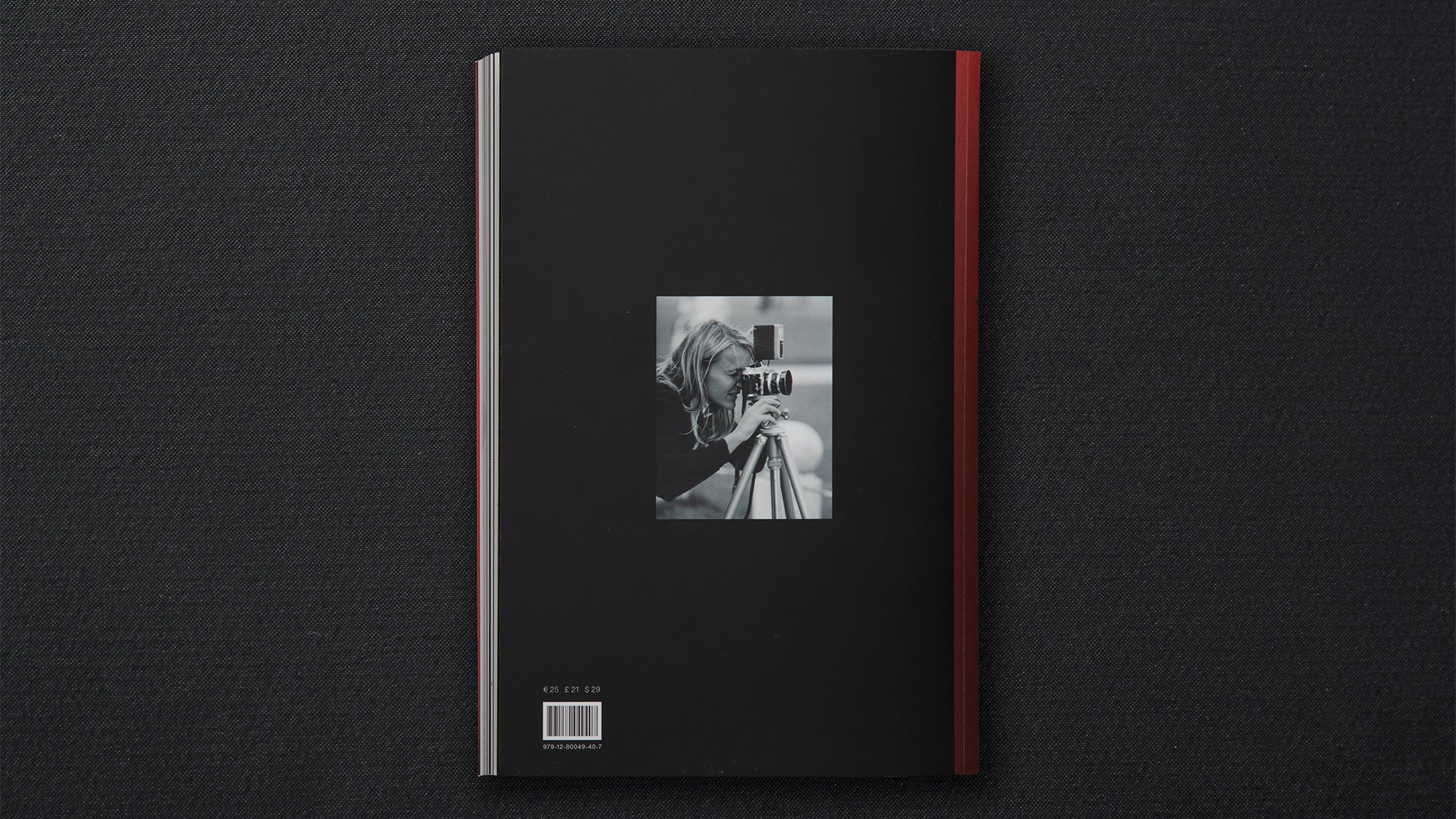 Black book cover with a red ribbon on a dark textured background